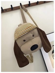 Close-up of cute dog-shaped corduroy backpack with striped hat and long plush ears