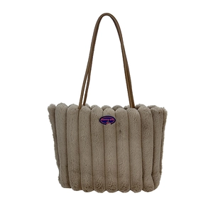 Plush khaki faux fur tote bag with striped texture and brown leather shoulder straps