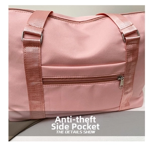Close-up of pink travel fitness bag showing anti-theft side zipper pocket detail.