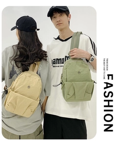 Detail of lightweight nylon backpacks with side drawstring pockets and metallic logo