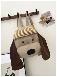 Detailed corduroy texture of the puppy backpack with adjustable straps and 3D ears