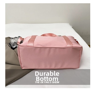 Macro view of the wear-resistant bottom on a large capacity pink fitness travel bag