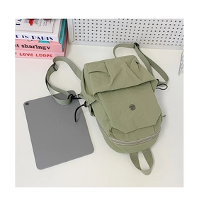 Detailed view of light green casual backpack storage capacity with a grey tablet