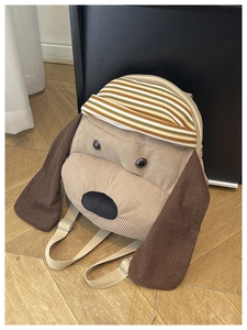 Close-up of puppy backpack showing khaki corduroy fabric and adjustable strap details