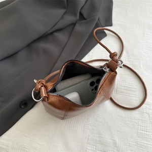 Brown faux leather crossbody bag with zipper closure and spacious interior for daily items