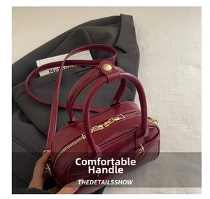 Top view of wine red crossbody bag with golden zipper and smooth leather texture