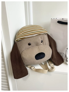 Detail view of the cute puppy backpack showing corduroy fabric and striped decorative handle