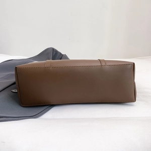 Bottom view of a retro brown leather tote bag showing high-quality stitching and base detail