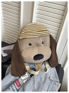 Detail of cute puppy corduroy backpack featuring 3D dog ears and striped knit hat design