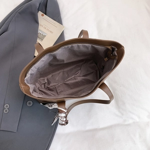 Brown faux leather tote bag with printed silk scarf and interior zipper closure