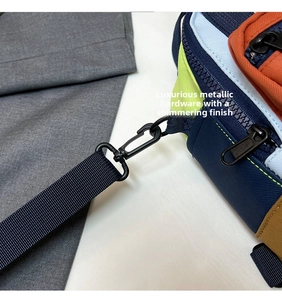 Detail of color-block mini bag showing textured nylon fabric and matte metal hardware