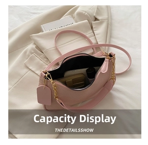 Detailed interior view showing storage capacity of this pink woven underarm bag