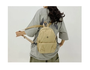 Khaki casual backpack in wrinkled nylon fabric shown on a model against white background