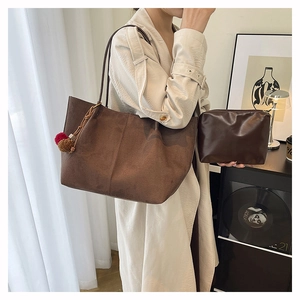 Suede tote bag set with matching inner pouch and plush fur charms for a stylish winter look