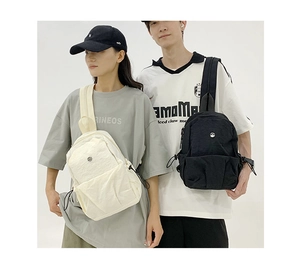 Detail of lightweight nylon chest bags with dual pockets and textured surface texture