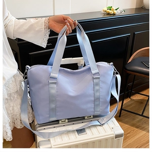 Large capacity purple travel bag with waterproof nylon fabric shown on a white suitcase