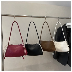Detail showing high-quality woven leather texture and drawstring on these hobo bags