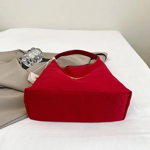 Vibrant red large canvas tote bag with embroidery, shown flat in a casual lifestyle setting