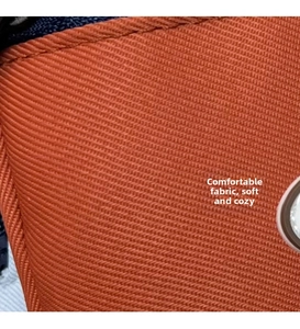 Close-up of bright orange twill fabric showing detailed weave texture and fine stitching