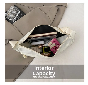 Internal view of a spacious dumpling bag showing wallet, books and cosmetics inside