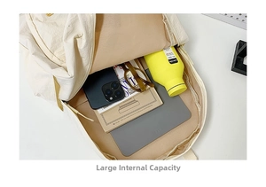 Close-up of internal large capacity storage with phone, tablet and water bottle inside
