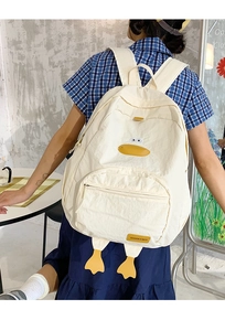 Detail of off-white cartoon duck backpack featuring yellow duck feet and fabric label