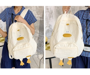 Detailed view of cartoon duck canvas backpack with 3D feet and multi-pocket design