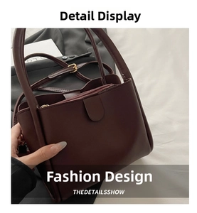 Detail of burgundy leather bucket bag showing zipper closure and side stitching quality