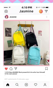 Detail of four colorful nylon backpacks in yellow, black, cream, and blue with 'M' logo