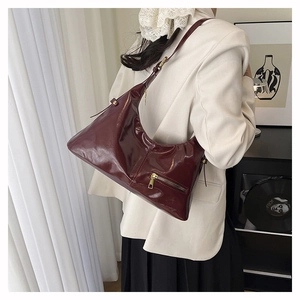 Detail of burgundy patent leather bag showing French retro style and glossy finish