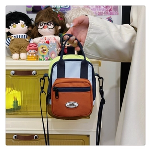 Close-up of a multi-color patchwork mini bag with adjustable strap and top handle