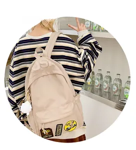 Detail of beige nylon backpack with USA relief and vintage patches in student style