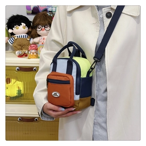Close-up of multicolor mini crossbody bag with zip pockets and adjustable strap