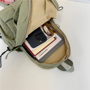 Versatile olive green nylon backpack with spacious main compartment for daily commute