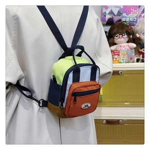 Rear view of a colorful mini crossbody bag with neon yellow and blue patchwork detail