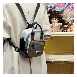 Rear view of model wearing a stylish colorblock mini nylon backpack with zipper pockets