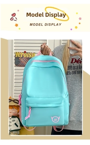 Detailed shot of light blue nylon backpack with pink zippers and cute wing logo detail