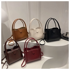 Minimalist bucket bags collection in five matte leather colors with circular handles