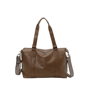 Brown vintage faux leather tote bag with wide geometric strap shown on white background