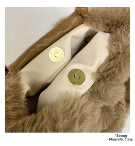 Detail of plush brown bag featuring strong double magnetic gold snaps and cream lining