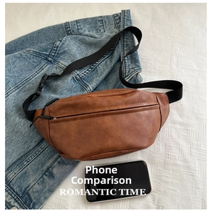 Brown vintage leather fanny pack shown with a mobile phone for size comparison