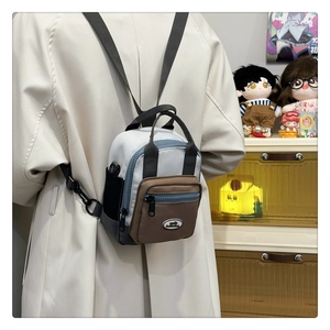 Detailed back view of a multi-color waterproof nylon mini backpack on a person