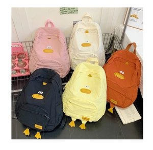 Detailed view of multiple colored cartoon duck backpacks with 3D feet and embroidery