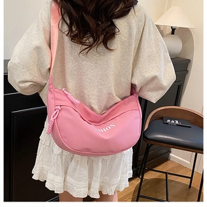 Pink crescent crossbody bag with white Fashion print and wide fabric shoulder strap