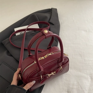 Vintage burgundy Boston tote bag with gold horsebit hardware and detachable strap for women