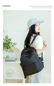 Detail of multi-compartment black backpack for commuting with side pockets and zippers