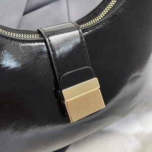 French retro black glossy leather underarm bag with gold metal buckle and zipper detail