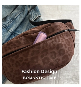 Detailed close-up of leopard print suede waist bag with black zipper and internal storage