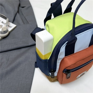 Vibrant color-block mini backpack with neon yellow and blue panels for stylish crossbody use