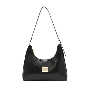 Glossy black hobo shoulder bag with golden buckle and zipper in a minimalist urban style